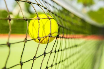 Foto op Canvas Tennis ball in net, closeup © Africa Studio