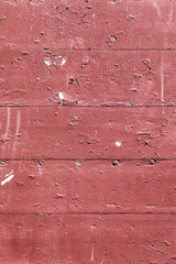 red wooden wall with peeling color