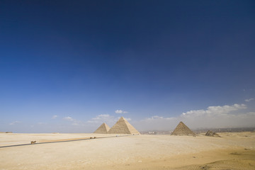 Fototapeta na wymiar Great Giza pyramids and blue sky with clouds