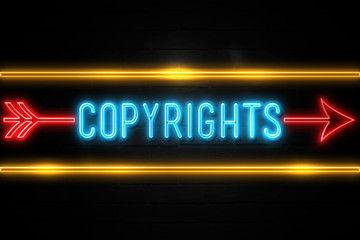 Fototapeta premium Copyrights - fluorescent Neon Sign on brickwall Front view