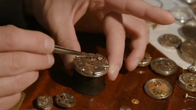 clockwork close up in the hands of a watchmaker