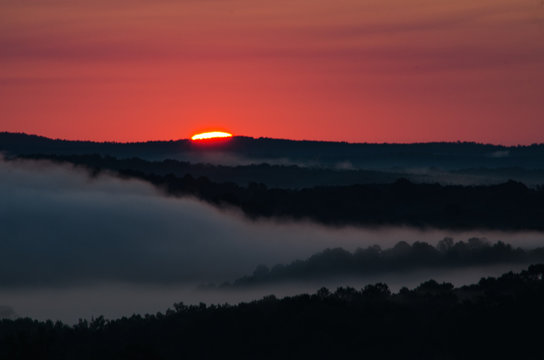 The start of a colorful sunrise over the foggy valleys near Heflin, Alabama, USA