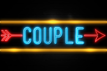 Couple  - fluorescent Neon Sign on brickwall Front view