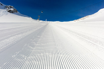 Fototapeta premium Newly groomed ski slope on a sunny day