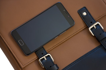 mobile phone on leather bag