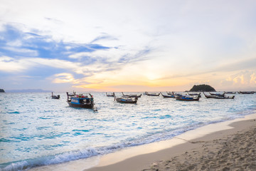 Naklejka premium Fishing boats on the beach at view seascape Lipe Island and beautiful light sunrise in morning