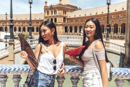 Chinese women standing leaning on fence