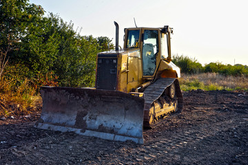 Obraz na płótnie Canvas Excavator at sunset, dirt