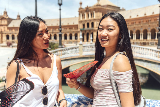 Chinese women standing leaning on fence