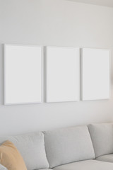 Fototapeta na wymiar Set of 3 Blank Poster Frames in a Living Room