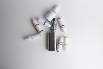 Isolated e liquid bottles and electronic cigarette, e cig for vape devices over a white background