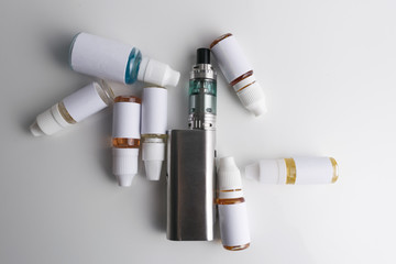 Isolated e liquid bottles and electronic cigarette, e cig for vape devices over a white background