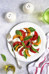 Traditional italian tomato salad caprese with mozzarella and basil.Top view with copy space.