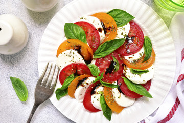 Traditional italian tomato salad caprese with mozzarella and basil.Top view .