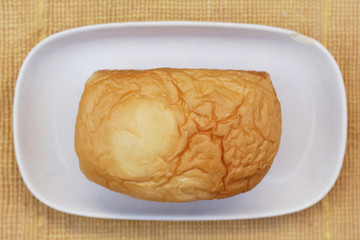 loaf of bread on wooden background, food closeup