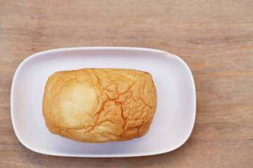loaf of bread on wooden background, food closeup