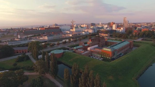 Aerial view of Malmo Castle and city at sunset. Drone shot flying over "Malmohus" in Sweden