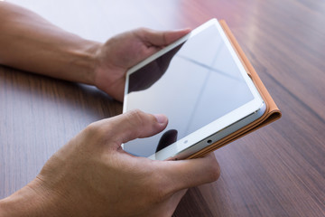 close up shot of man hand holding tablet