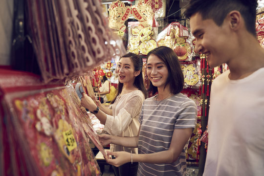 Three friends shopping for decorations in Chinatown