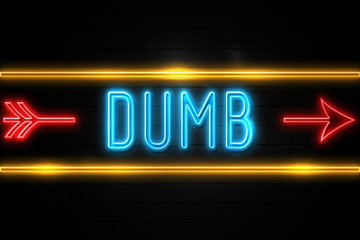 Fototapeta premium Dumb - fluorescent Neon Sign on brickwall Front view