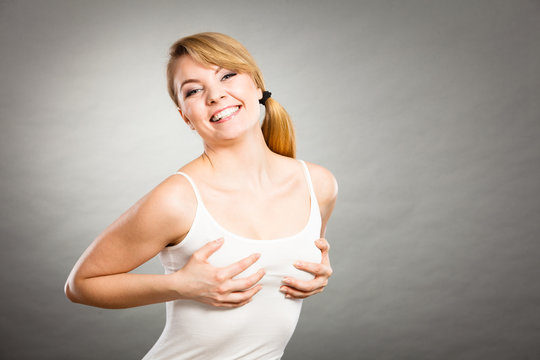 Joyful woman holding hands on her breast