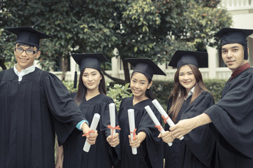Group of graduate students holding their diploma