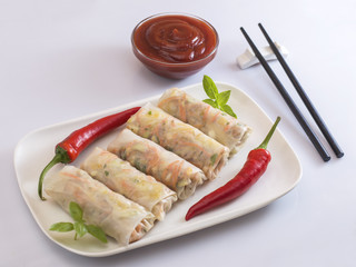 Fresh vegetables spring rolls on white plate. 