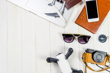 Hi Tech Travel objects and gadgets for modern traveler with white wooden copy space