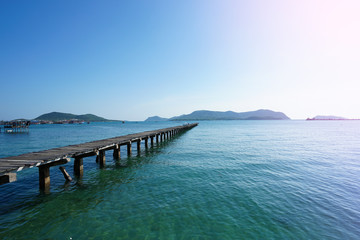 Obraz premium Wooden bridge into the sea. Property is located at the end of the runway into the sea