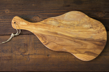 Background with cutting board made of olive wood 