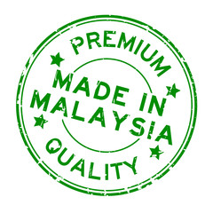 Grunge green premium quality made in Malaysia round rubber seal stamp on white background