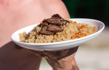 Pilaf in a plate in a cafe