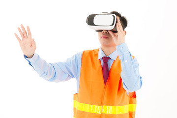 Young confident asian man, orange safety hat, orange safety jacket, safety glass, red tie, blue shirt on white using VR headset.