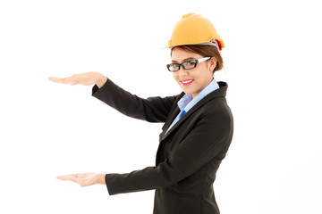 Young attractive confident asian woman, orange safety hat, glass, black suit, blue shirt on white background pose open hand.