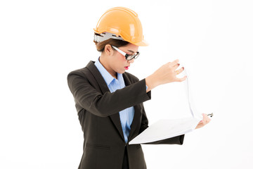 Young attractive confident asian woman, orange safety hat, glass, black suit, blue shirt on white background checking blueprint.