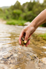 Small stones in the hand on the pond