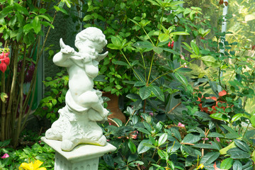Figurine of an angel playing the flute in the garden