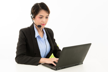 Young attractive confident Asian female business woman in suit blue shirt with headset and laptop on white background.