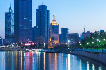 illuminated city waterfront downtown skyline with Haihe river,Tianjin,China.