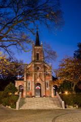 Fototapeta na wymiar Autumn Beautiful night view of Gongseri Catholic Church in autumn colors.