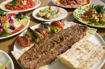 Kebab; healthy and fresh salad varieties and appetizer on wooden table