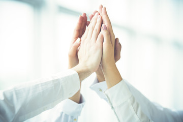 The four hands greeting with a high five