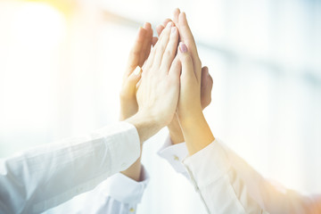 The four hands greeting with a high five