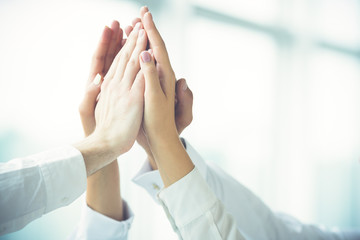 The four hands greeting with a high five