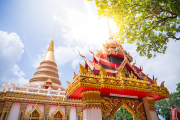 Public temple in Countryside with green tree branch on top and sunflare, Thailand