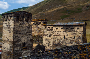 Village Ushguli landscape with massive rocky mountains Bezengi wall, Shkhara on the background in Svaneti, Georgia