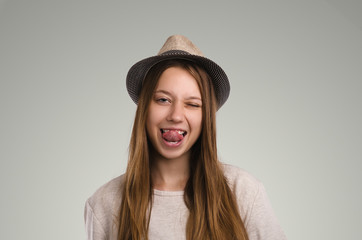 Positive casual woman posing. Emotional girl portrait. Young female with hat. The model is looking at the camera.