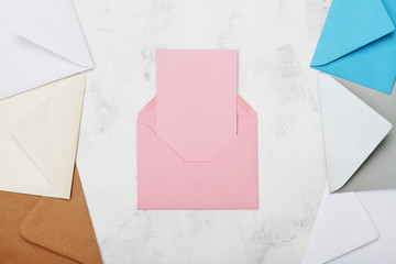 Opened mail envelope with empty card mockup or template top view. Business or private correspondence background. Flat lay.