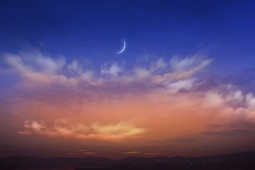 Sunset and new moon . Paradise heaven  . Against the background of clouds . beautiful sky .  peaceful sky for the Muslim . Against the background of clouds .