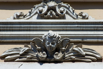 Brown architecture detail with human head